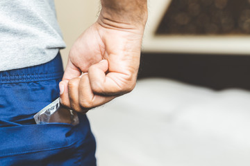 Male hand holding Condom. Safe sex concept.