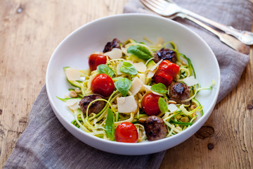 Meatballs with zucchini pasta and tomatoes