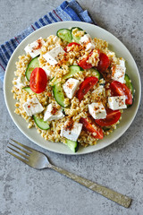 Healthy salad with bulgur, vegetables and feta. Middle Eastern style.
