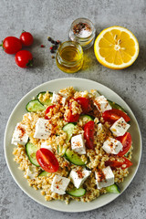 Healthy salad with bulgur, vegetables and feta. Middle Eastern style.