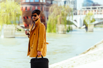 Handsome businessman with briefcase in down town