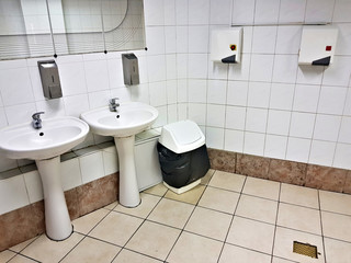 Public restroom decorated in white colors