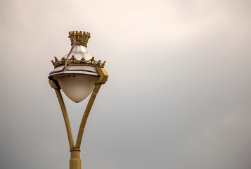Beautiful vintage street lamp of the colonial town of Iza, photographed against the overcasted sky, in the Andean mountains of central Colombia.