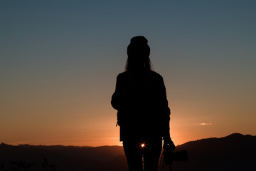 The silhouette of climbing with the camera looking at the sunset