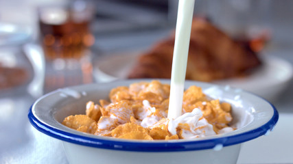milk poring on corn flakes