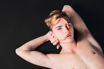 Fototapeta premium Male beauty. Young guy and little snake.