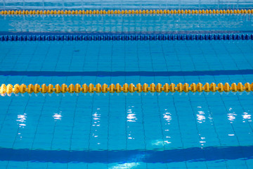 Surface Of The Pool With Blue Water And Colored Dividers Of Swimming Tracks