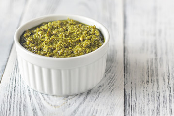 Bowl of pesto on the wooden table