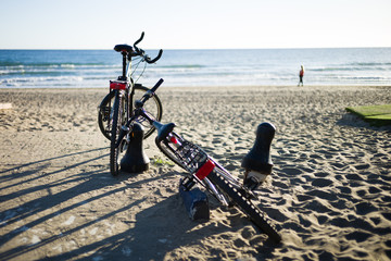 Two bicycles meet at the beach in beautiful light