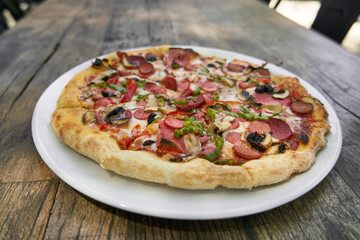 Delicious pizza served on porcelain plate
