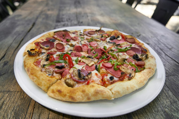 Delicious pizza served on porcelain plate