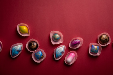 Colorful bonbons on red background
