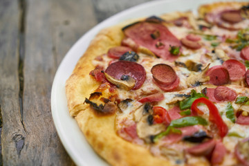 Delicious pizza served on porcelain plate