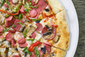 Delicious pizza served on porcelain plate