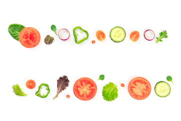 Fresh vegetable salad ingredients, shot from above on a white background. A flat lay composition with tomato, pepper, cucumber, onion slices and mezclun leaves, forming a frame for copy space