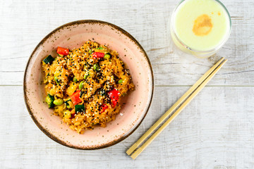 Tyahan - fried rice with chicken and vegetables in a bowl on the table