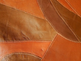 Genuine leather background. Pieces of leather of different shades.