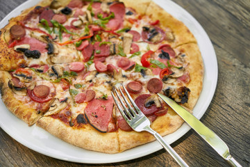 Delicious pizza served on porcelain plate
