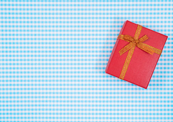 gift box with red isolated on Plaid background. Holiday decoration for Mother's Day or Women's Day.