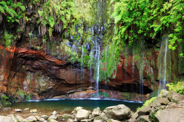 Fototapeta premium Beautiful landscape view of the 25 Fontes falls, a cascade waterfall at the end of a levada hike on the island Madeira