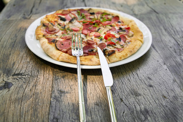 Delicious pizza served on porcelain plate