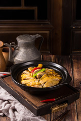 Stewed chicken used rice wine in a black ceramic dish