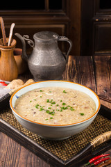 Stewed chicken porridge in a ceramic bowl