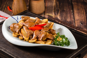 Braise pig's large intestines in soy sauce in a white ceramic dish