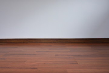 white wall and wood laminate floor in empty room