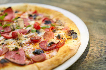 Delicious pizza served on porcelain plate
