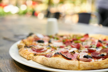Delicious pizza served on porcelain plate