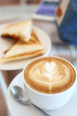 hot latte coffee drink and sandwich put on table breakfast in the morning day