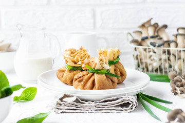 Pancake bags stuffed with with fried oyster mushrooms with spinach