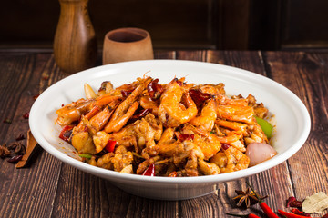 Fried spicy bullfrog and chicken with chilli in a white ceramic dish
