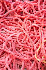 Fruit jelly, sprinkled with sugar. Sweets, dessert, sweets in the form of worms or snakes. Baby...