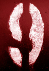 Number 9 in stencil on metal wall in red tone.