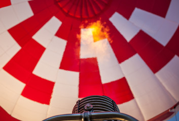 Hot air balloon or aerostat, bright burning fire flame from gas burner equipment, close up from inside, short focus