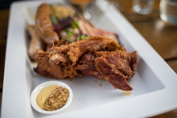 Close up of roasted pork chops with masturd seeds sauce