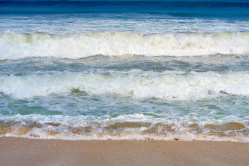Ocean waves on the famous Kuta Beach. Nature background.