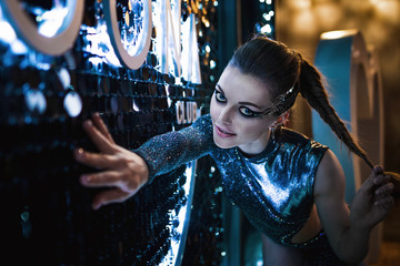 Gorgeous young girl in a stage image. Striptease, dancing on the pylon. Portrait photo