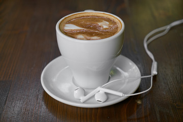 Cup of hot coffee latte on a wooden table