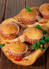 Vanilla cupcake, homemade pastry on wooden background