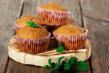 Vanilla cupcake, homemade pastry on wooden background