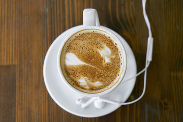 Cup of hot coffee latte on a wooden table