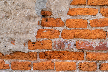 Close up of empty Old Brick Wall Texture. Painted Distressed Wall Surface. Grungy Wide Brickwall. Grunge Red Stonewall Background. Shabby Building Facade With Damaged Plaster.