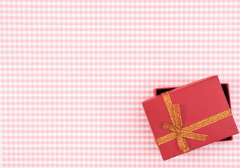 gift box with red isolated on Plaid background. Holiday decoration for Mother's Day or Women's Day.