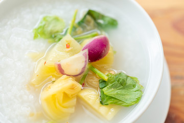 Close up delicious pickled cabbage mixed with purple onion, chilli and celery over rice soup.