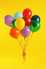 Bunch of bright balloons on color background. Celebration time