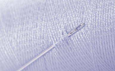 Grey threat with needle