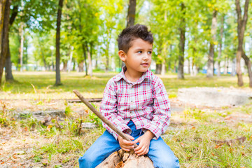 boy in the Park sitting on a log